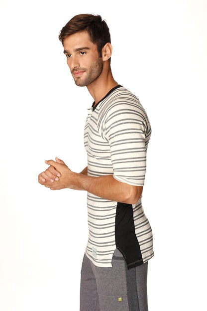 A man wearing a 4-rth mens vintage-stripe henley tee in dark grey double stripe french terry loop with black side panel