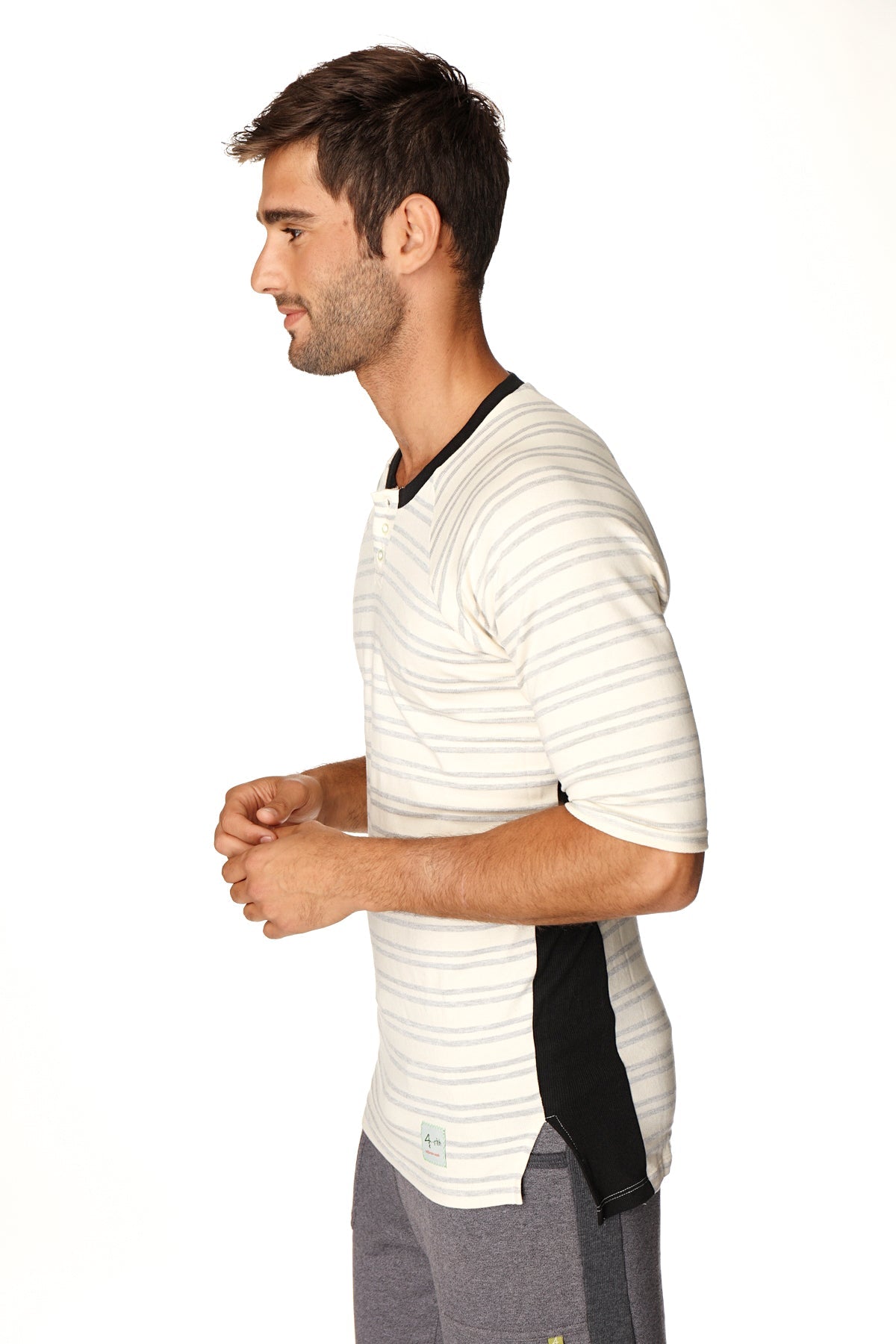 A mens short-sleeved henley shirt with horizontal white and gray stripes black ribbed collar side panel accents in french terry loop