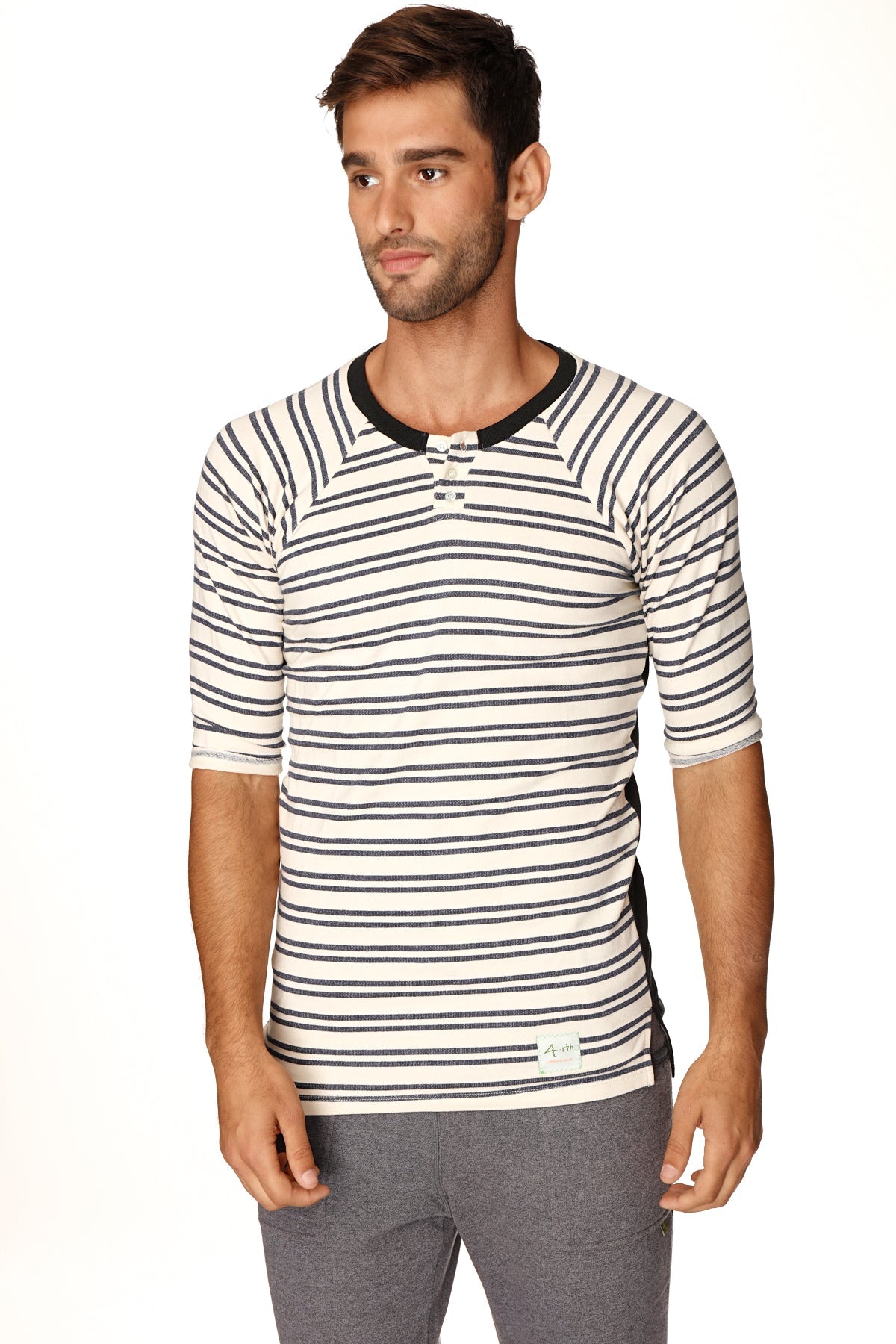 A mens short-sleeved cream and navy striped henley shirt with black ribbed collar and button placket in french terry