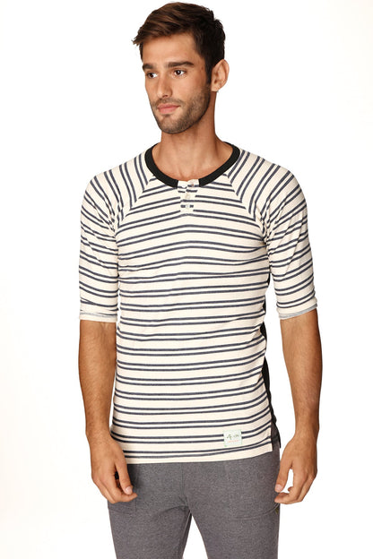 A mens short-sleeved cream and navy striped henley shirt with black ribbed collar and button placket in french terry