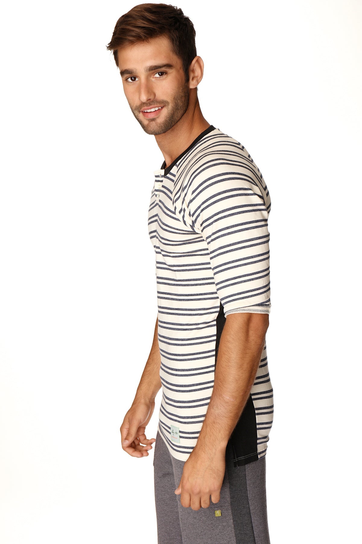 A man wearing a 4-rth mens vintage-stripe henley tee in navy double stripe french terry loop with black side panels