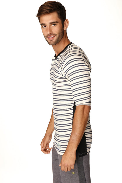 A man wearing a 4-rth mens vintage-stripe henley tee in navy double stripe french terry loop with black side panels