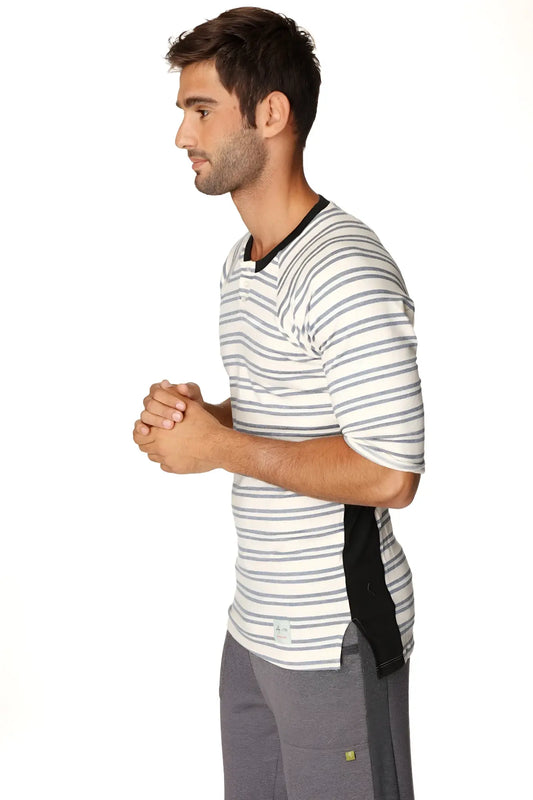 A man wearing a 4-rth mens vintage-stripe henley tee in cool blue stripe french terry loop with black trim