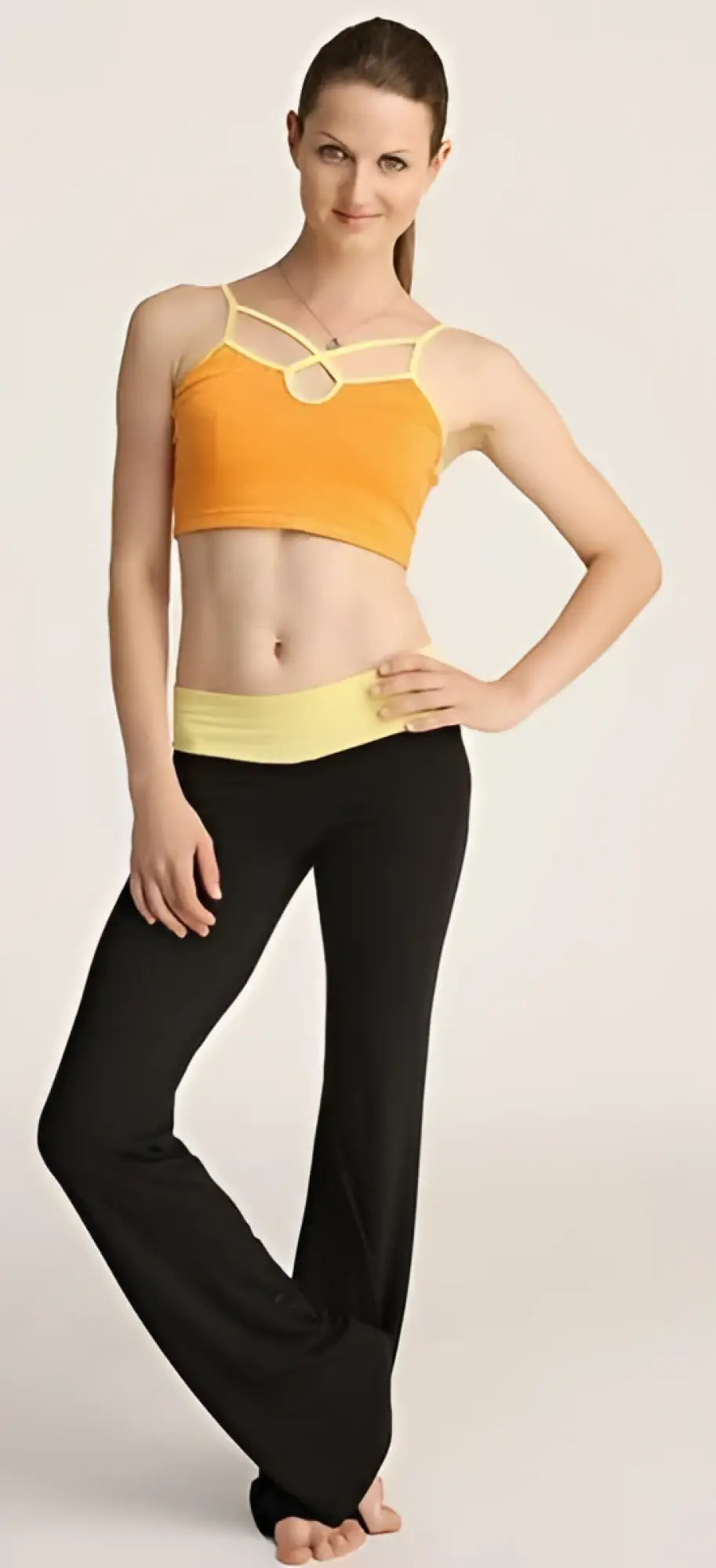 4-rth women’s classic yoga pant paired with an orange and yellow sports bra with thin straps and front circular cutout