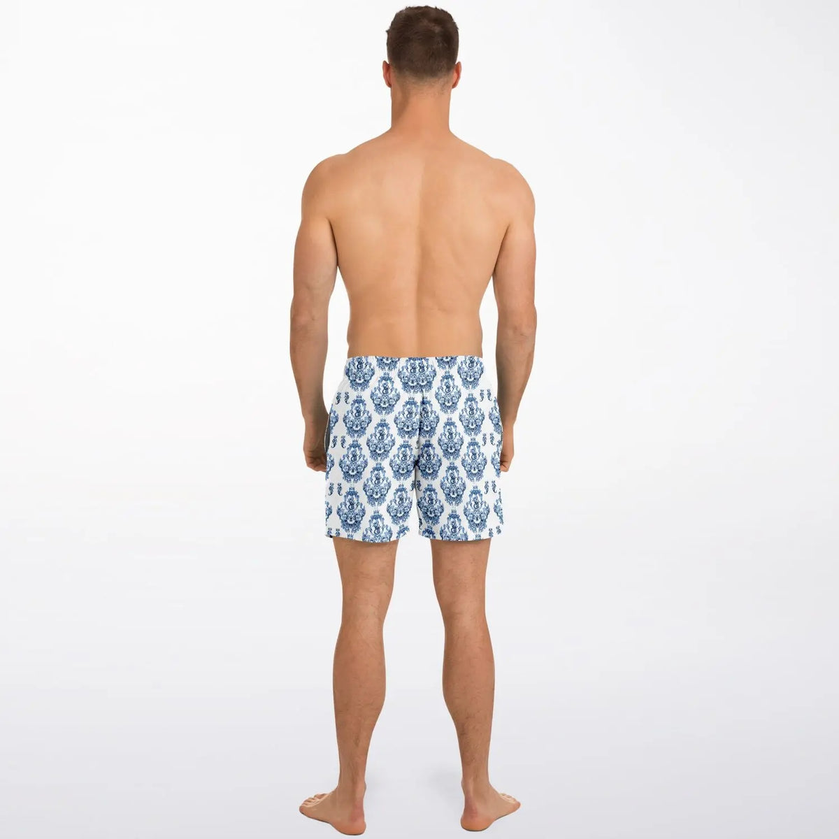 Men's swim shorts in blue and white baroque pattern made by Maris Equi shown from the back on a model.