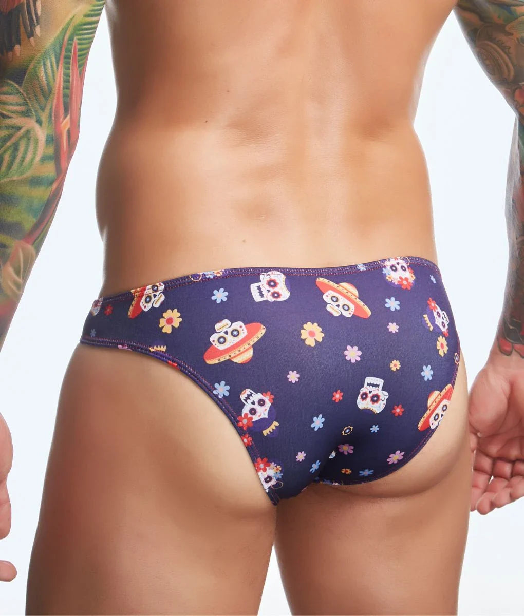 Dark blue mens swim trunks by justin + simon featuring a fun print of cartoon skulls with sombreros and flying saucers