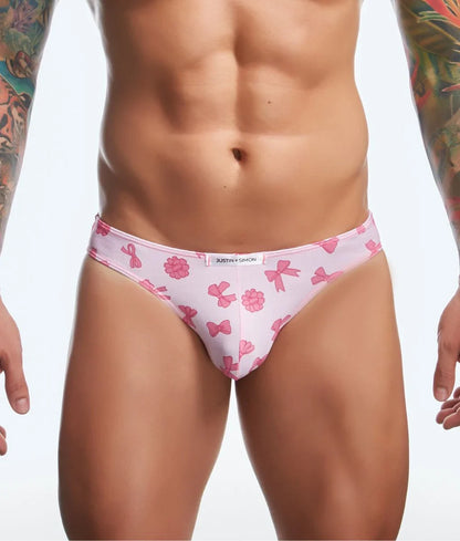 Pink patterned briefs with bow and flower designs and white brand tag from justin + simon classic mens bikini fun prints
