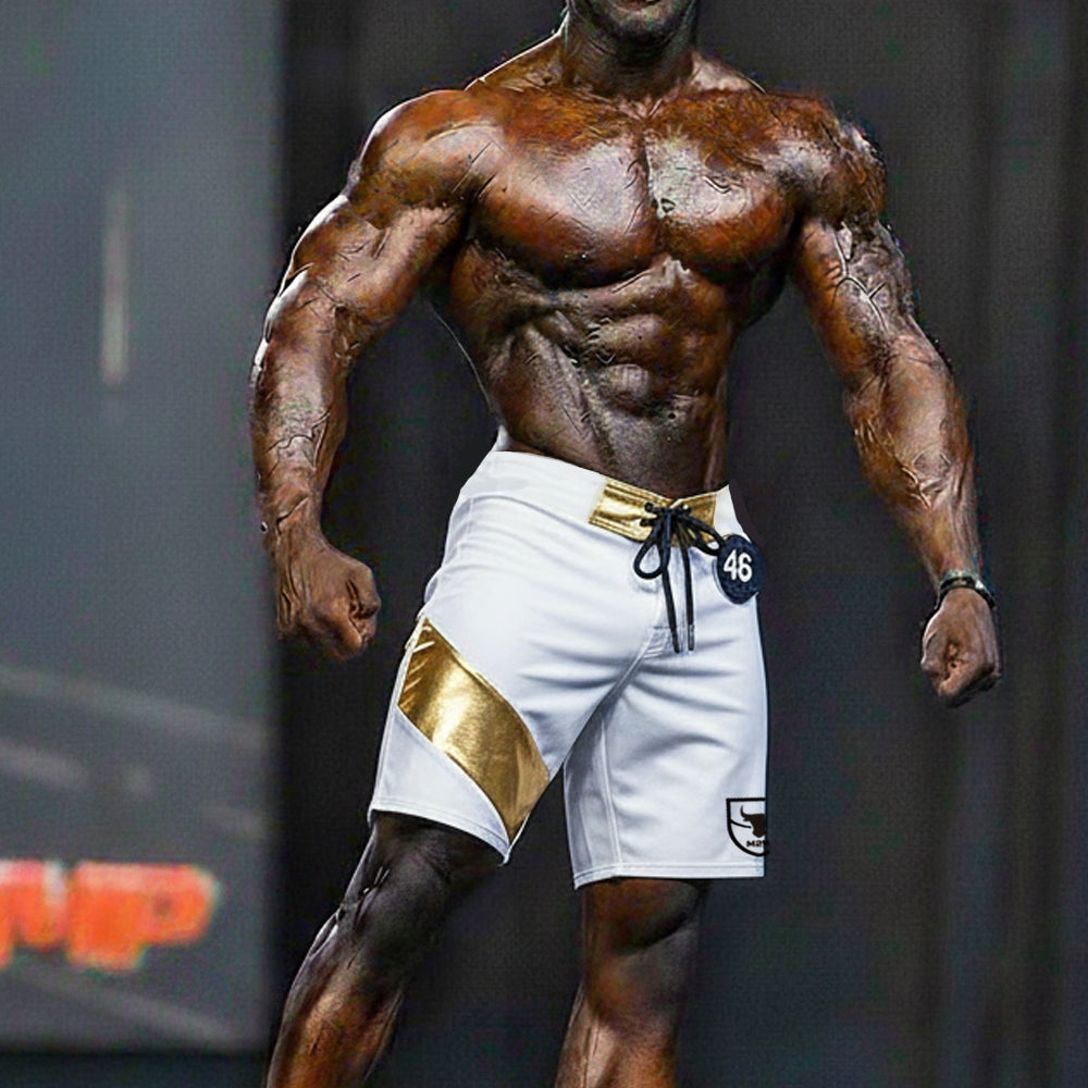 White MetroMaleWear Physique board shorts with gold diagonal stripe, gold belt loop, black drawstring, and logo patch
