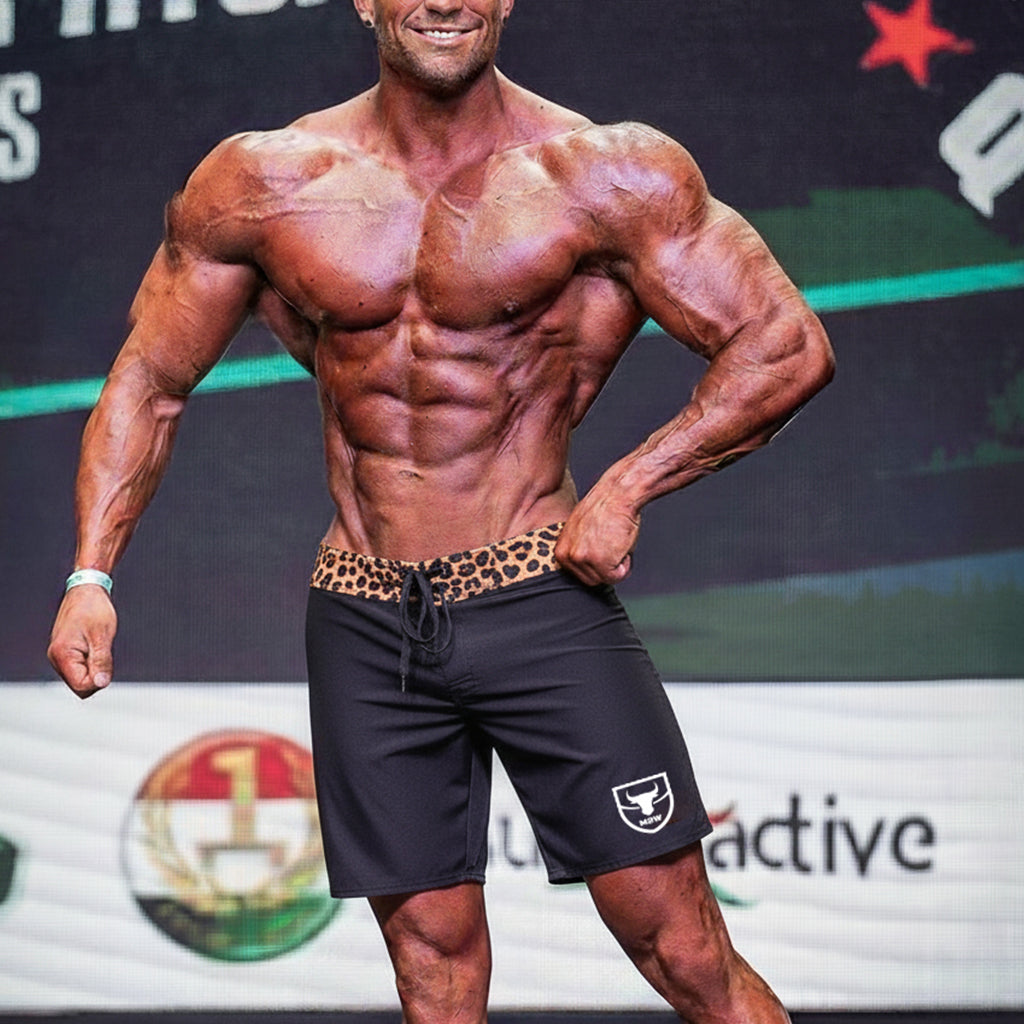 Black athletic shorts metro malewear physique board short with leopard print waistband and white shield logo on left leg