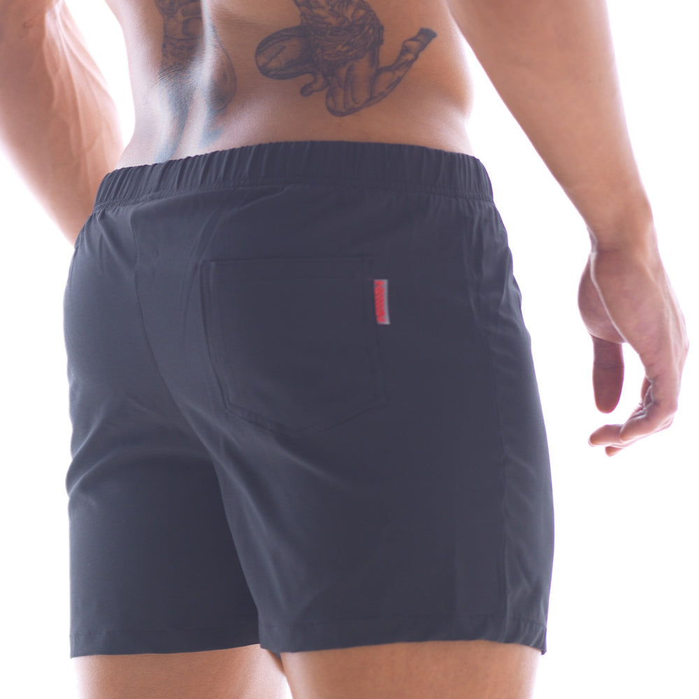 Back side of metroMalewear flexible swim trunk black 4710-20 showing dark navy shorts with red and white stripe on pocket