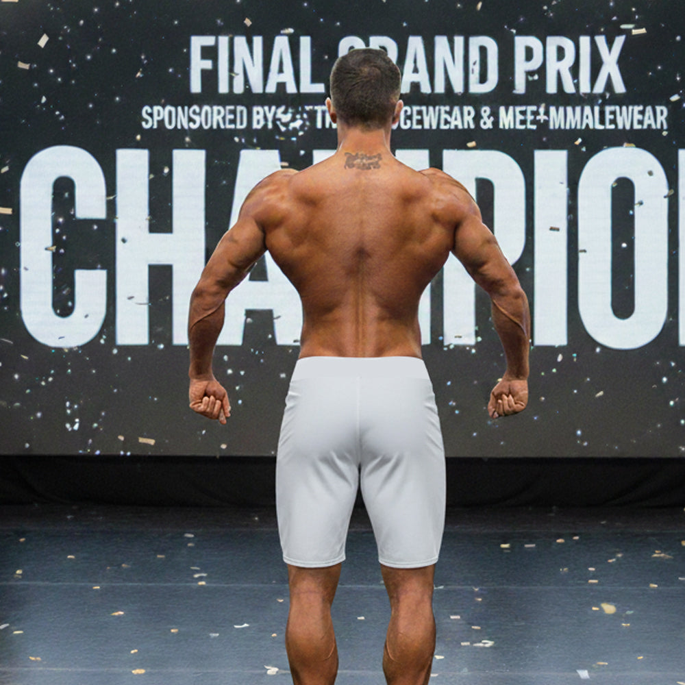 A muscular man shown from the back wearing gray metro musclwear insignia physique board shorts by metromalewear