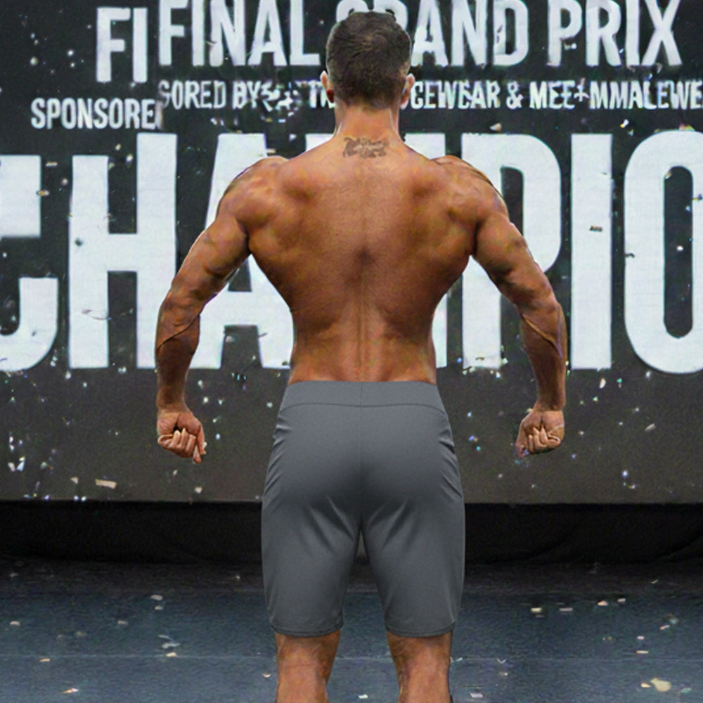 Gray athletic metromusclewear insignia physique board shorts worn by muscular man in charcoal color