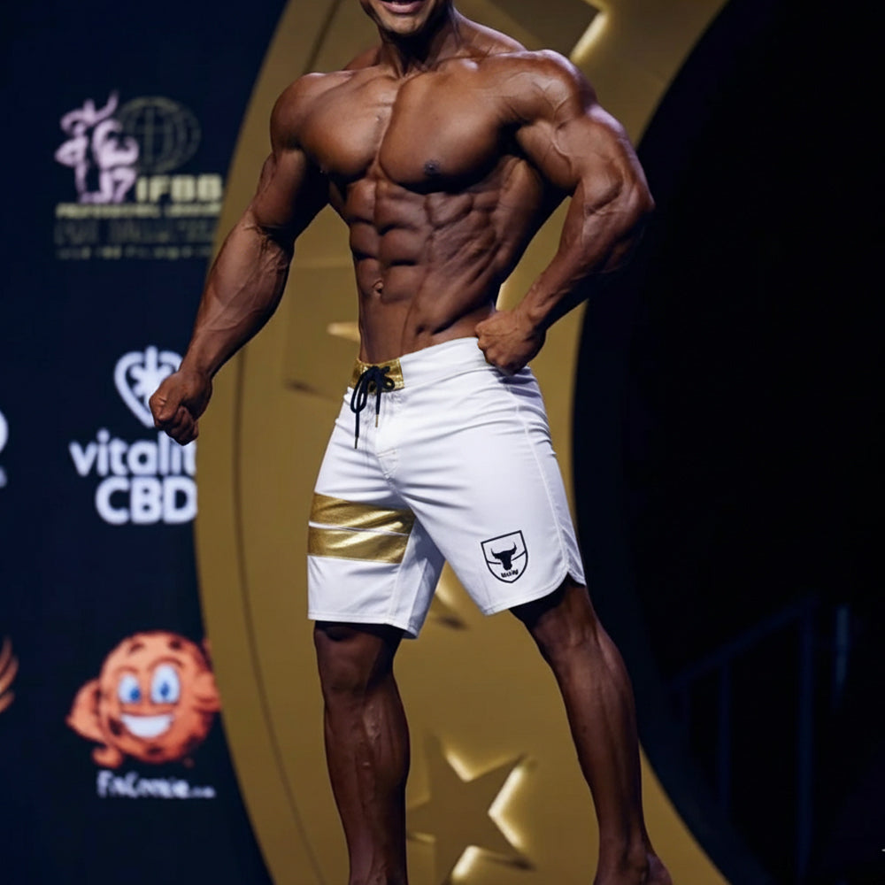 White athletic shorts with gold stripe and black drawstring featuring small shield logo on left leg by metromalewear
