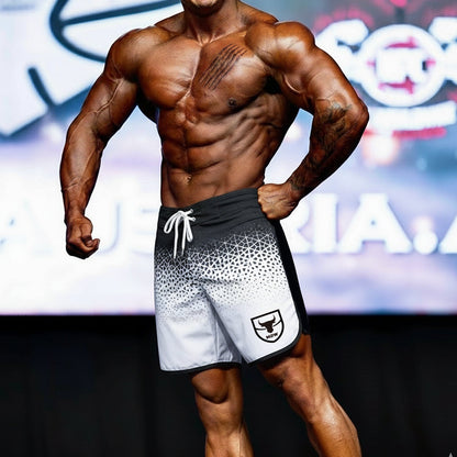 Black and white geometric-patterned athletic board shorts with white drawstring and shield logo on lower left leg by MetroMaleWear