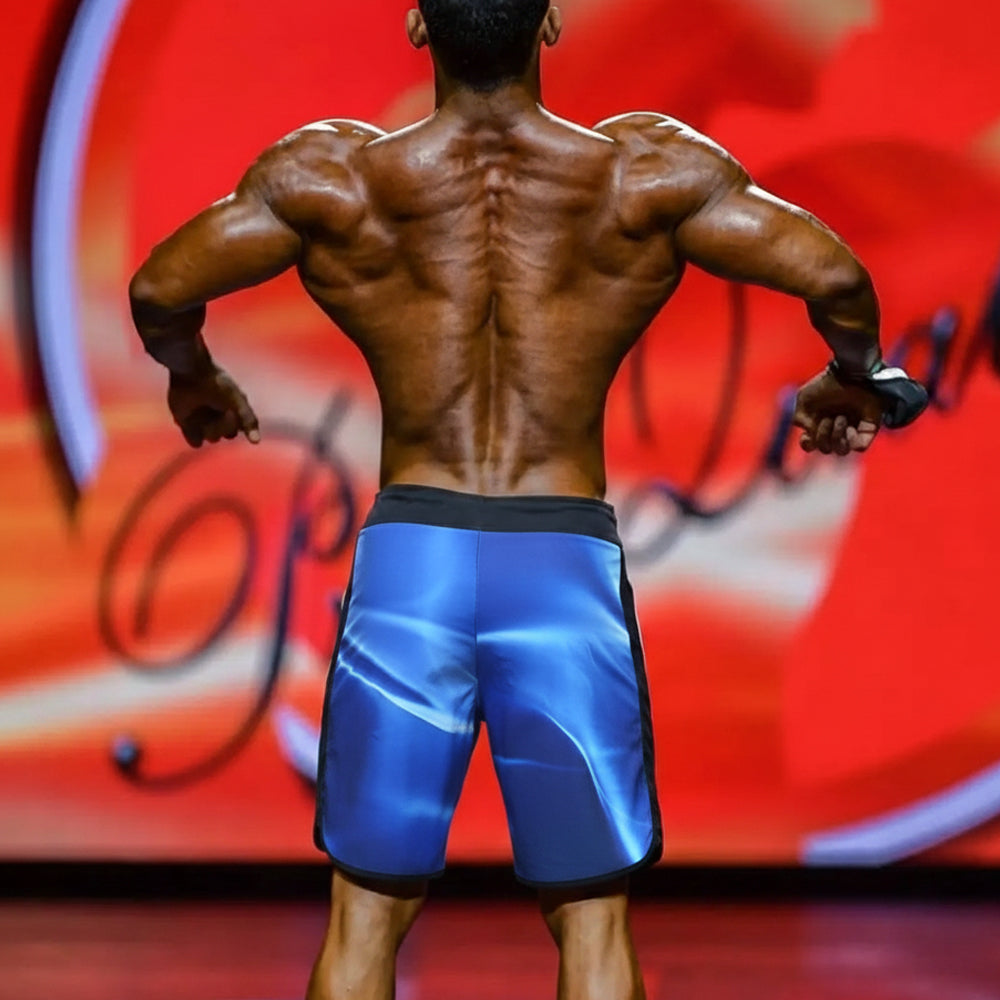 Blue metromalewear IFBB Pro mens physique board shorts with glossy reflective finish and black trim for athletic use