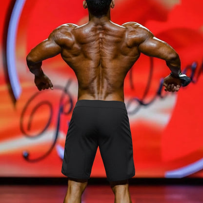 A muscular man’s back showcasing defined shoulder blades wearing metro malewear ifbb pro men’s physique board short colombia