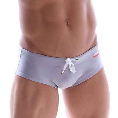 Light gray MetroMaleWear swim briefs with white drawstring and red brand tag on the waistband for comfortable swim use