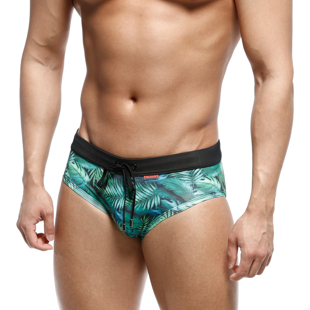 Green tropical leaf-patterned swim trunks with black elastic waistband and drawstring from MetroMaleWear