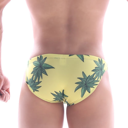 Yellow swim bikini by MetroMaleWear featuring a repeating green cannabis leaf pattern for classic beachwear