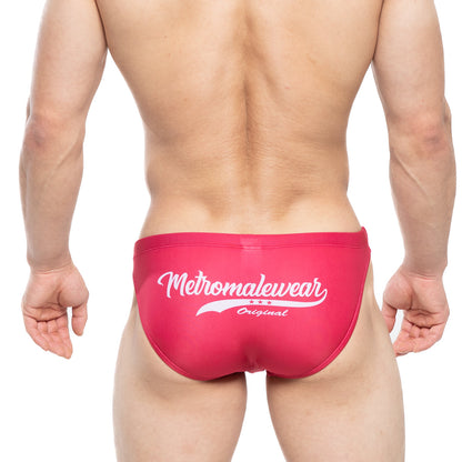 Bright pink mens swim bikini surf trunks with white metromalewear original logo and three stars