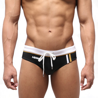Black MetroMaleWear Edge swim brief with white waistband gold trim and white drawstring for stylish swimwear use
