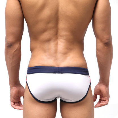 White swim trunks with navy blue trim and red side accents from MetroMaleWear Tebai swim brief 4956-00