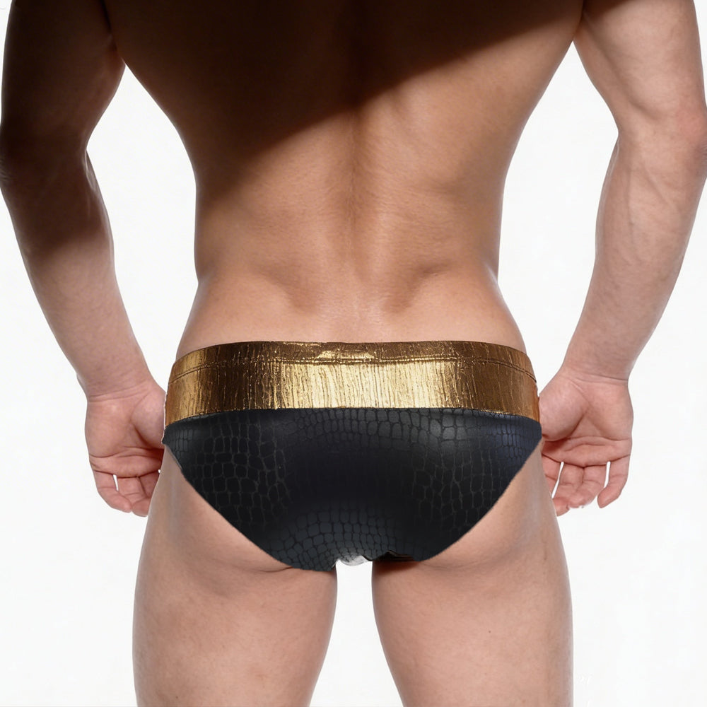 Black swim trunks with textured crocodile pattern and shiny gold waistband from metromalewear fortuna competition suit