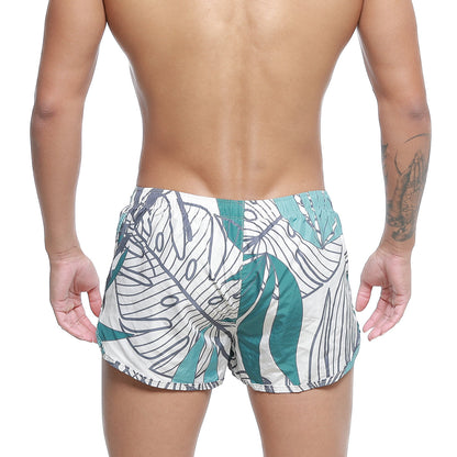 White swim trunks with bold teal and black tropical leaf pattern metroMalewear summer swim shorts meadow 4988-09
