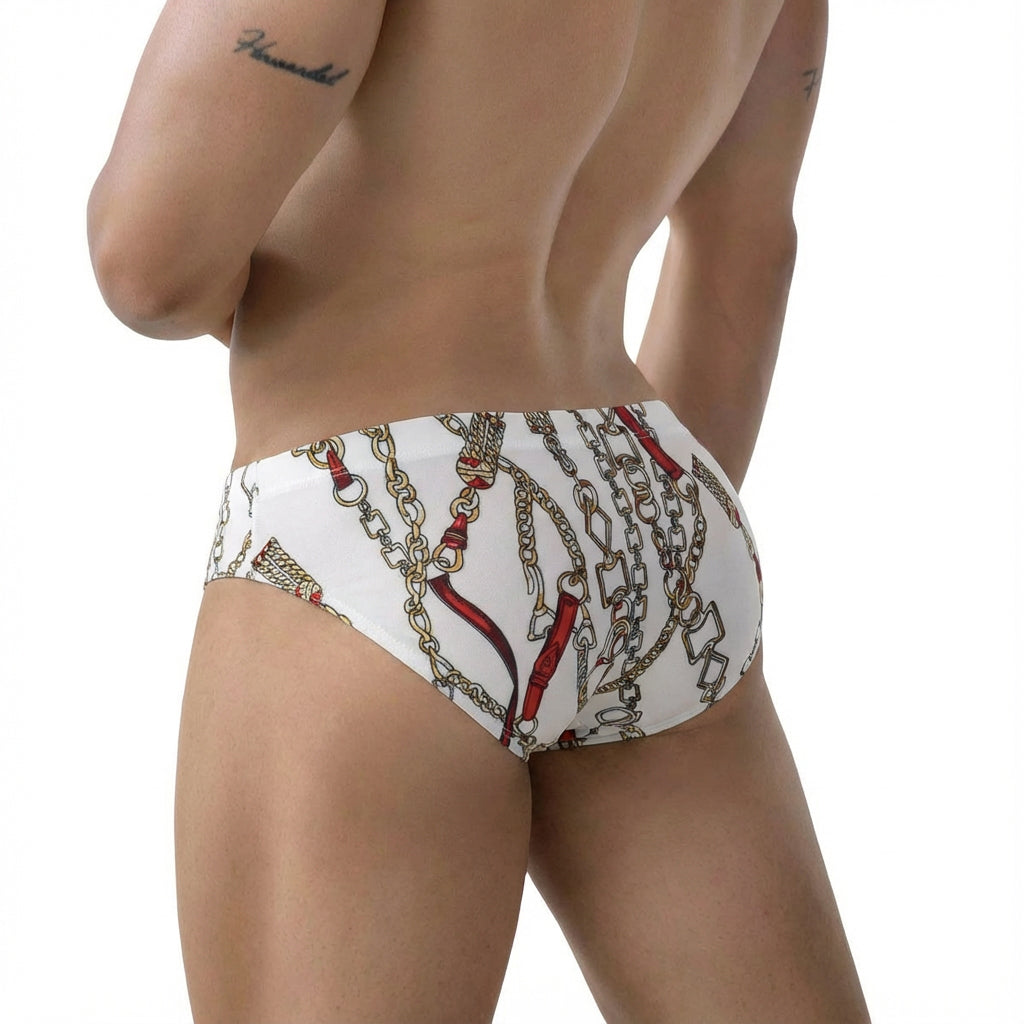 White briefs metroMalewear tiki bikini 5103-89 with a bold gold and red chain pattern on a white fabric