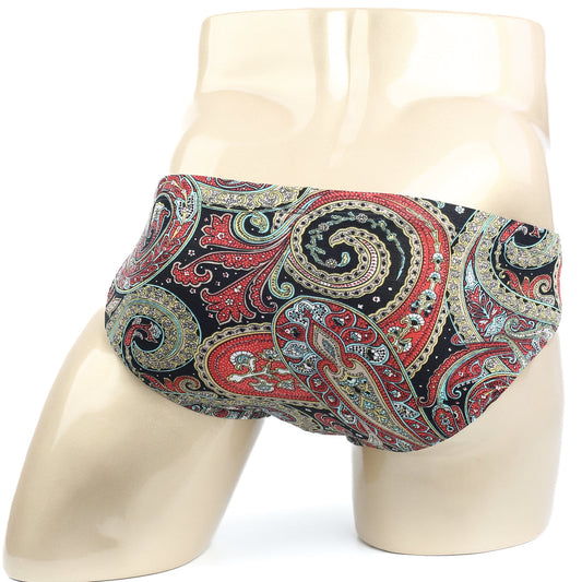 Vibrant red gold and teal paisley pattern men’s briefs by MetroMaleWear displayed on a mannequin