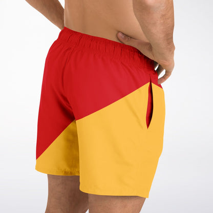 Men's swim shorts by Maris Equi featuring a red and yellow color block design elastic waistband and side pockets.