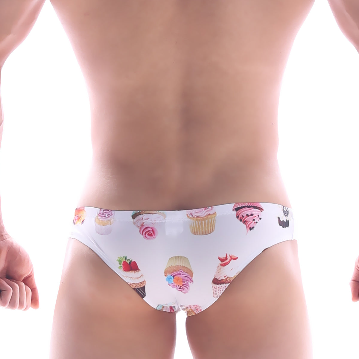 White MetroMaleWear Capri bikini swim trunks with colorful cupcake and frosting pattern for playful beachwear