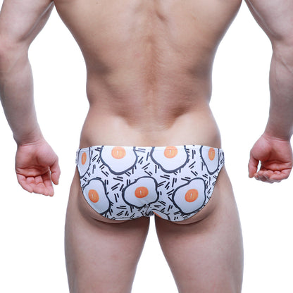 White swim trunks by MetroMaleWear with cartoon fried egg pattern and black line accents lowrise bikini 6115-67