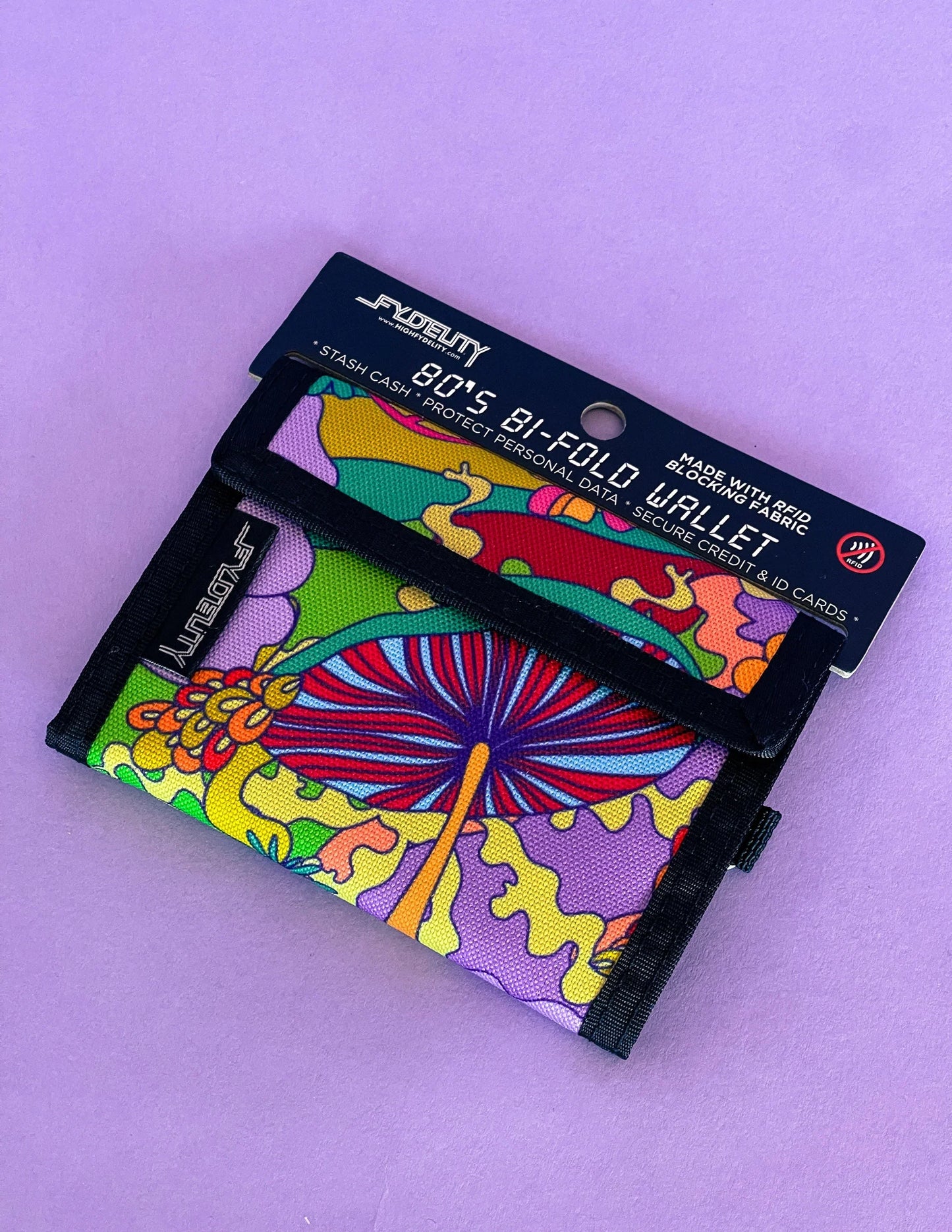 A vibrant psychedelic patterned 80s velcro wallet with colorful mushroom floral design on fabric material