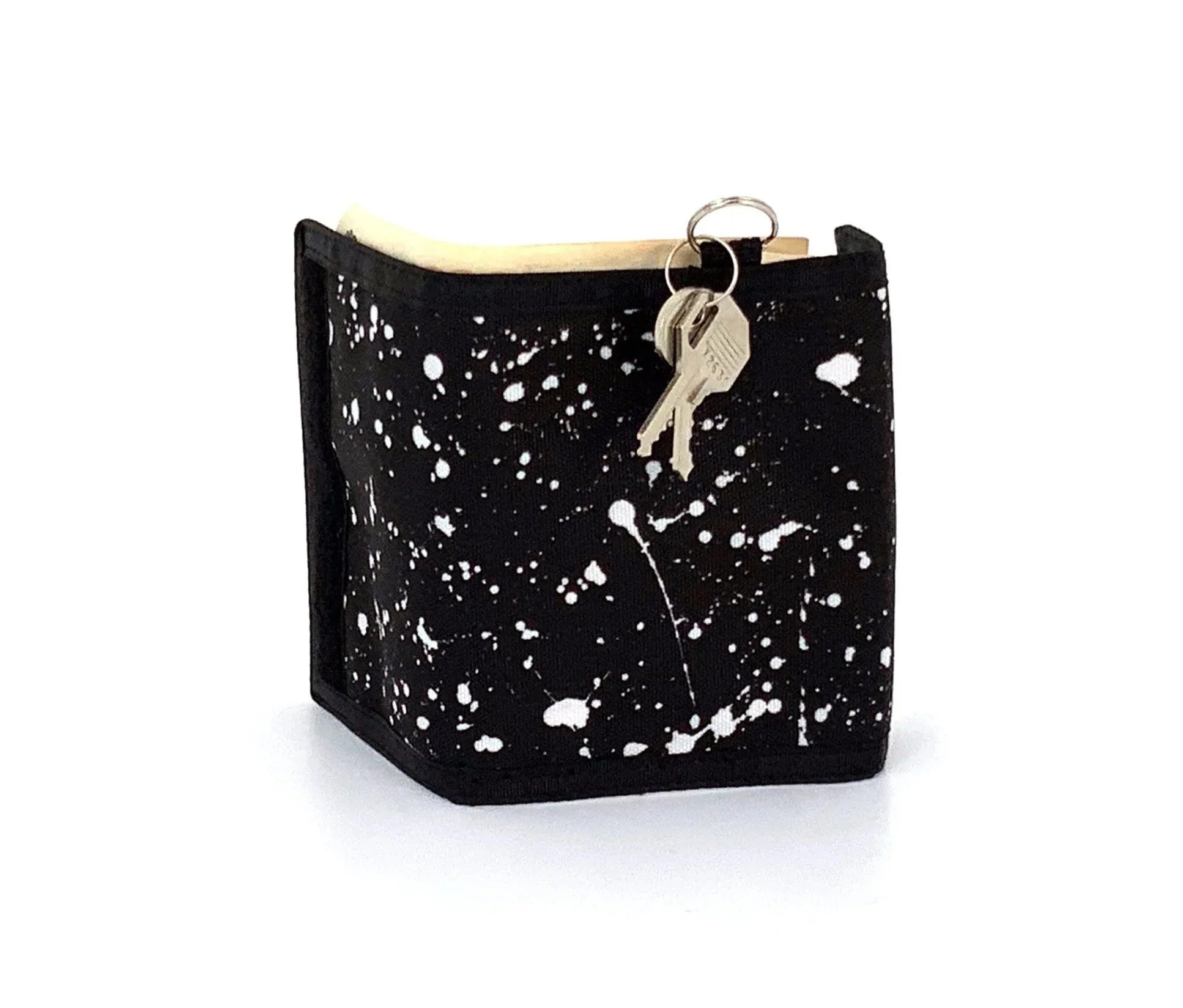 Black 80s velcro wallet with white paint splatter design featuring key ring and attached keys on top