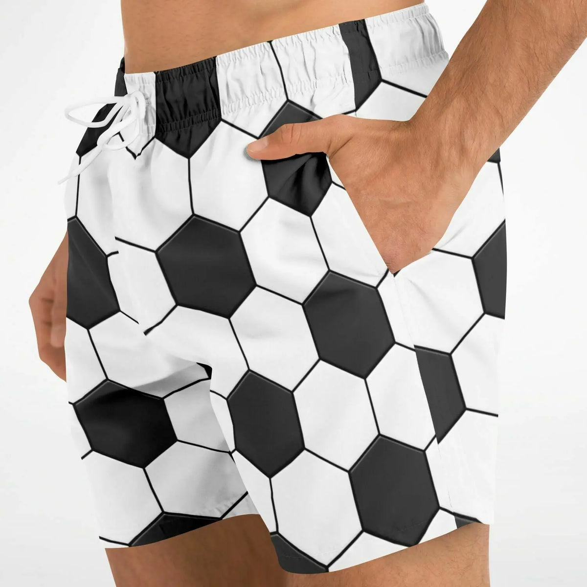 Men's swim shorts by Maris Equi featuring a black and white hexagonal soccer ball pattern with side pockets and an elastic waistband.