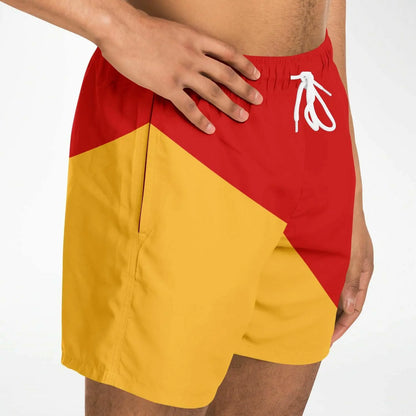 Men's swim shorts by Maris Equi in red and yellow with a geometric design featuring an elastic waistband and side pockets.