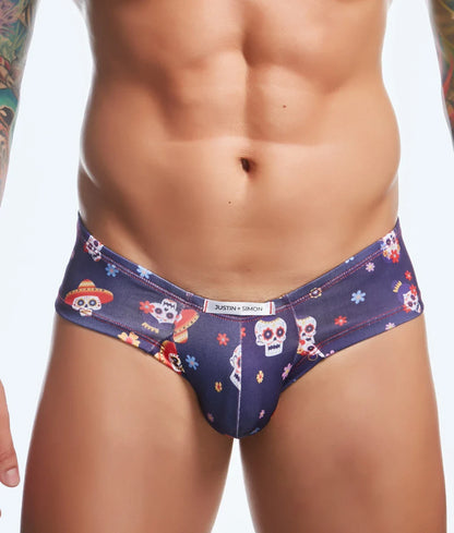 Dark blue men’s briefs with a vibrant sugar skull pattern and floral accents from justin simon cheek fun prints