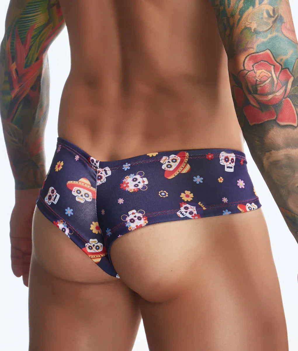 Dark blue swim trunks by justin + simon featuring vibrant sugar skull and floral patterns for fun prints