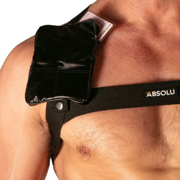Black pocket harness featuring a sleek design adjustable straps and a small pouch worn by a model by Absolu Male By TOF Paris