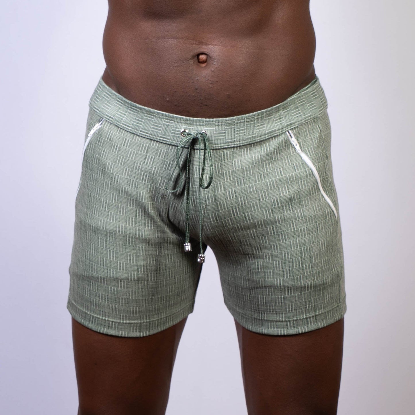 Olive green abstract linen texture shorts with white zipper accents and drawstring waistband for casual wear