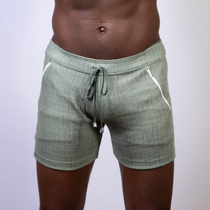 Olive green abstract linen texture shorts with white zipper accents and drawstring waistband for casual wear