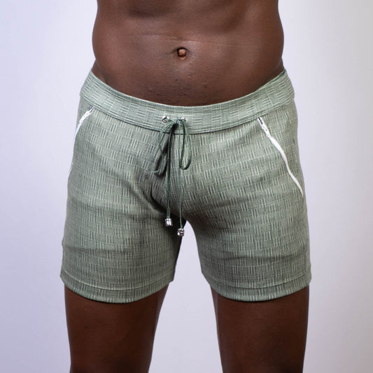 Olive green abstract linen texture shorts with white zipper accents and drawstring waistband for casual wear