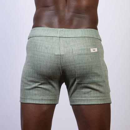 Mint green abstract linen texture shorts with subtle woven pattern and branded label on the back waistband