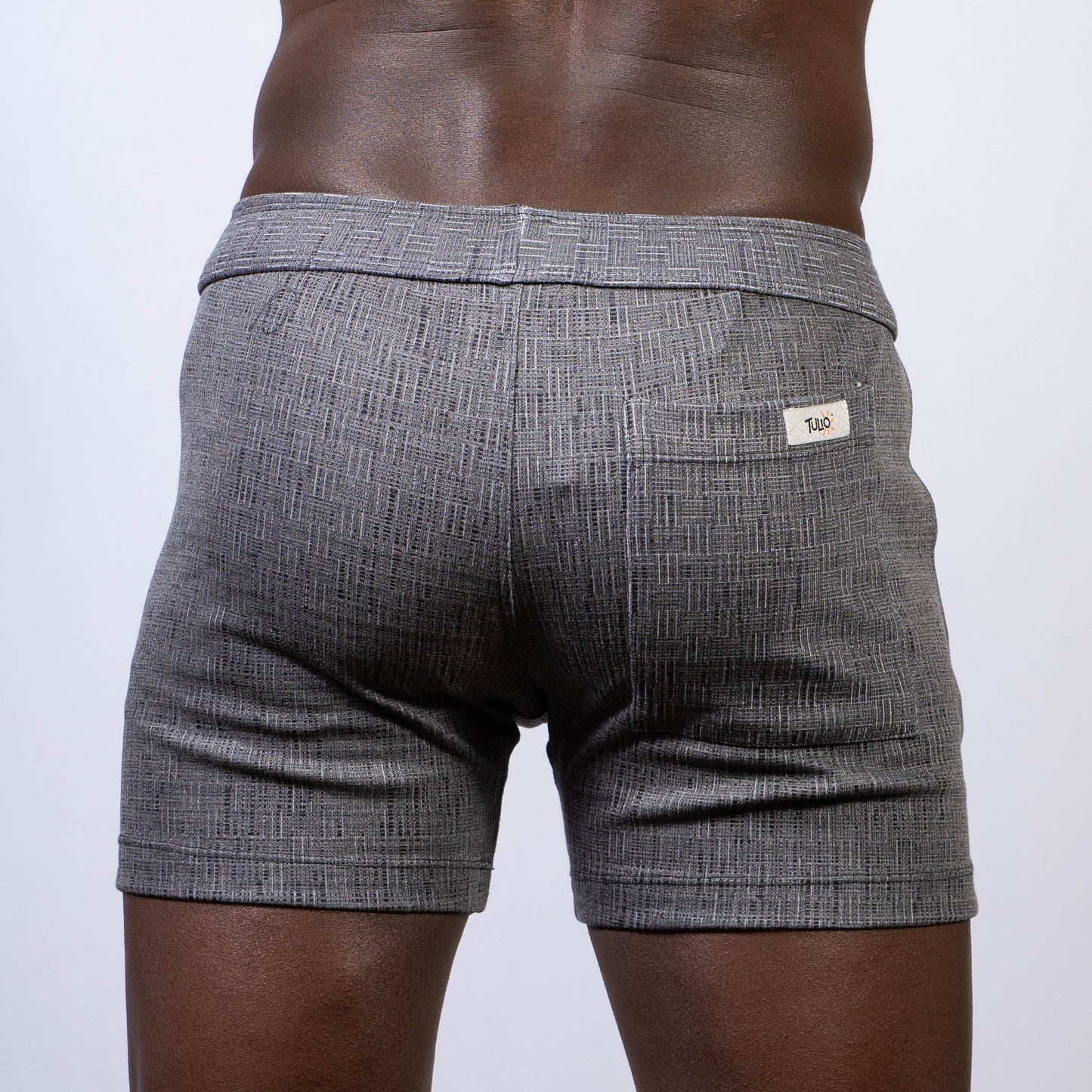 Gray textured abstract linen texture shorts with subtle herringbone pattern and white brand tag on back waistband