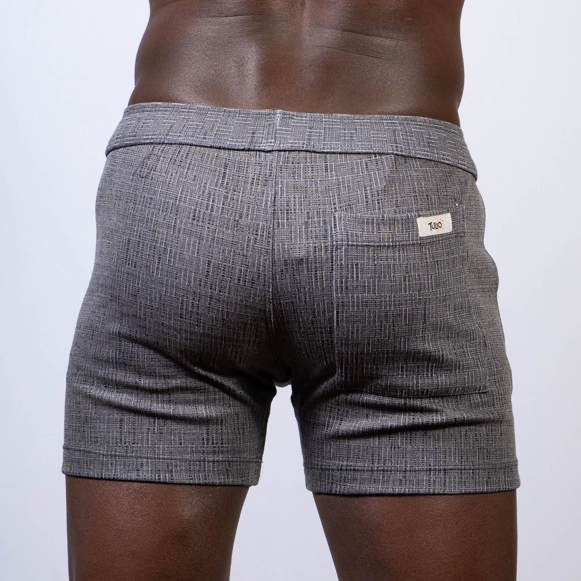 Gray textured abstract linen texture shorts with subtle herringbone pattern and white brand tag on back waistband
