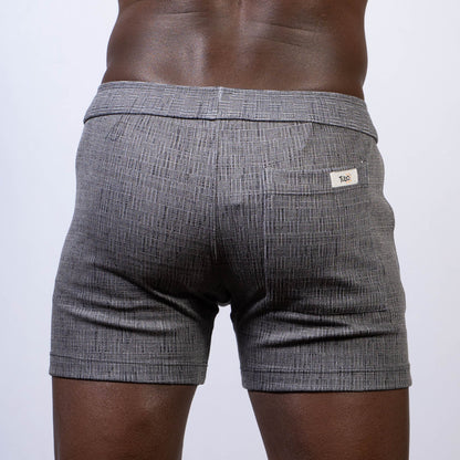 Gray textured abstract linen texture shorts with subtle herringbone pattern and white brand tag on back waistband