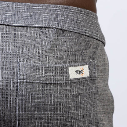 Back side of gray abstract linen texture shorts with subtle geometric pattern and white tulio brand label on pocket