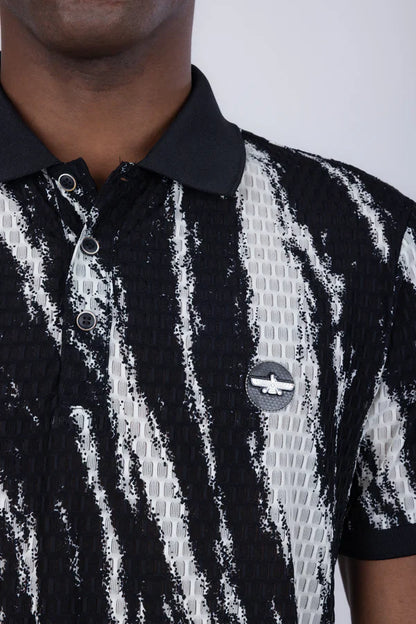 Abstract polo shirt in black and white patterned textured fabric with a circular logo patch on the chest