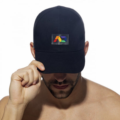 Black baseball cap featuring a colorful geometric logo patch on the front in the ad rainbow cap style